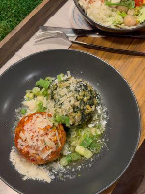 A bowl of spinach and tomato dumplings in a mountain hut