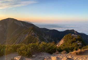 Mountain ridge between Herzogstand and Heimgarten in the Bavarian Alps at sunrise, with golden light over peaks and valleys above Lake Walchensee – iconic view from the Four Elements guided ridge hike.