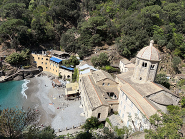 Historic San Fruttuoso Abbey by the sea surrounded by green hills and turquoise water