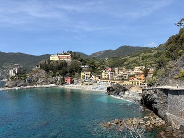 View of Monterosso al Mare with colorful seaside houses, hillside villa, and turquoise sea in Cinque Terre, Italy
