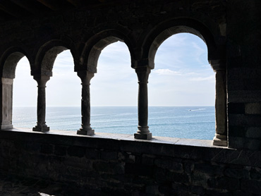 View of the Ligurian Sea through stone arches of San Pietro Church in Portovenere, Italy