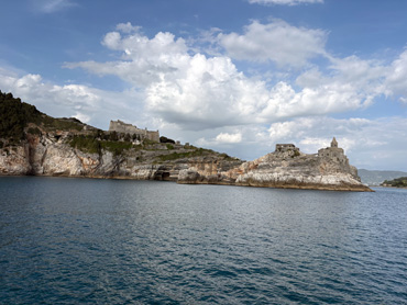 View of San Pietro Church and fortress on rocky cliffs above the blue sea in Portovenere, Liguria