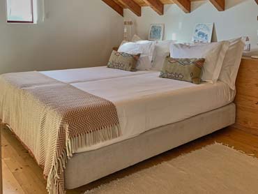 Twin bed rooms with two beds, cushions under wooden roof