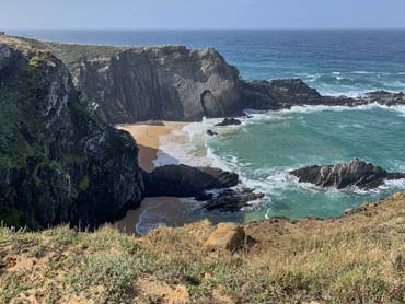 A secluded beach with rocks and ocean