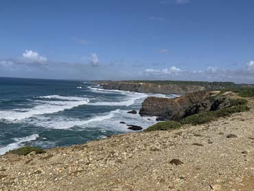 Waves rolling in and cliffs above